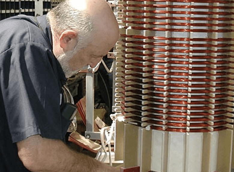 Technician working on a dry type transformers coils.