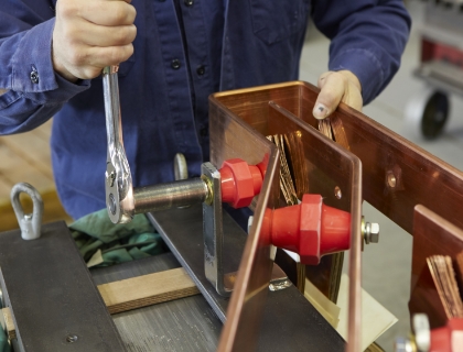 Transformer technician retrofitting dry type transformer.