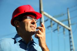 Worker using a walkie-talkie to communicate.