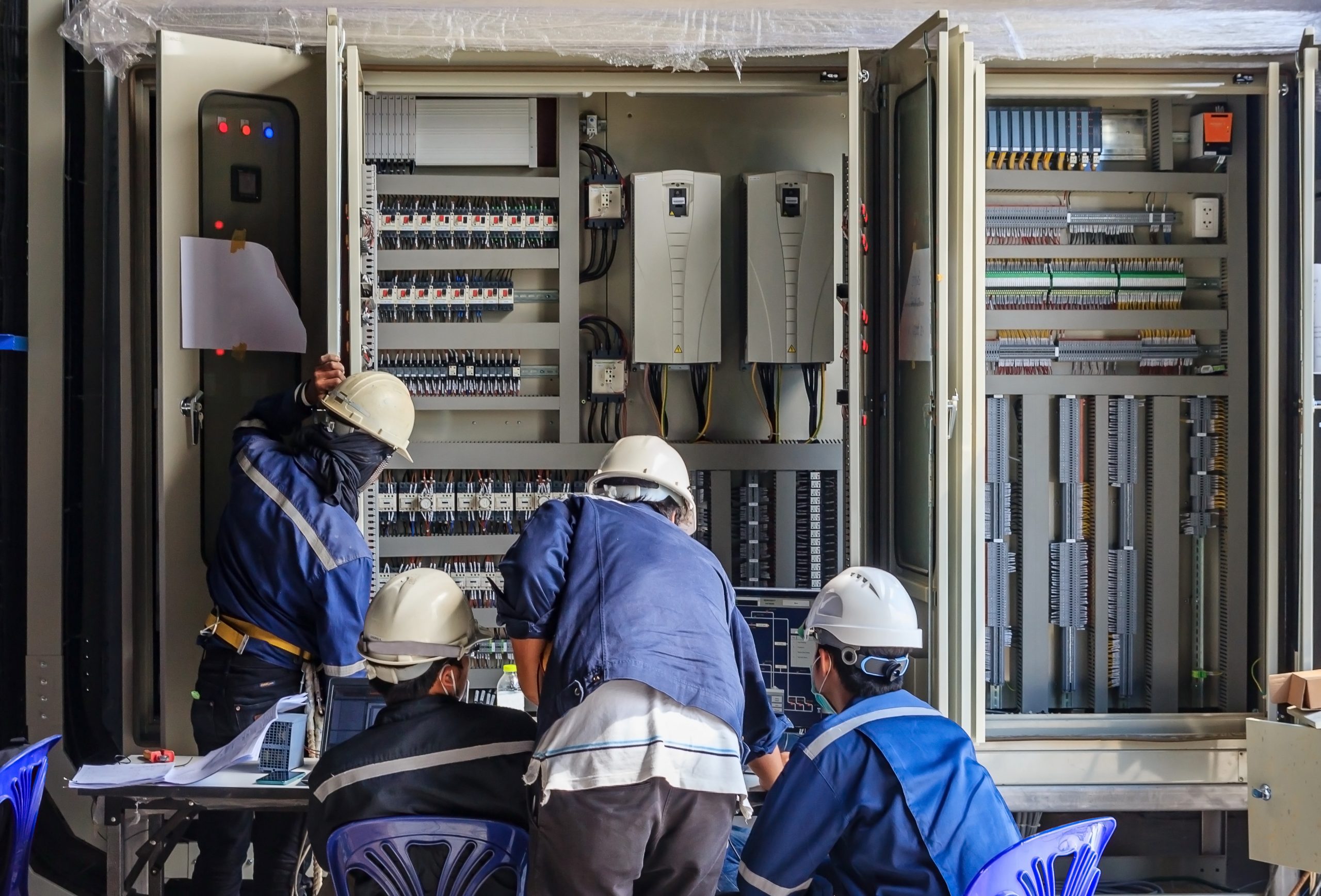 Workers fixing a transformer 