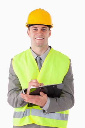 Man wearing a hard hat and wearing a reflective vest.